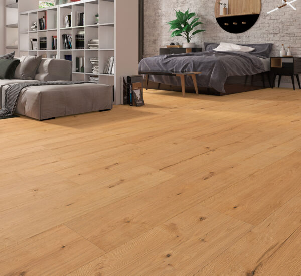 Albendo, vloeren specialist - Moderne slaapkamer met Laminaat Warm Eiken vloeren, grijs beddengoed op een netjes opgemaakt bed, een ronde spiegel erboven, boekenplanken en een gezellige grijze bank, allemaal tegen een witte bakstenen muur.