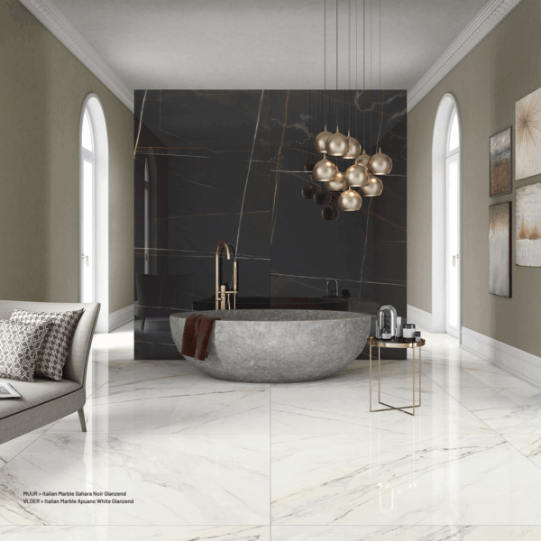 Albendo, vloeren specialist - Een moderne badkamer heeft een groot ovaal stenen bad, een gouden kraan, een zwart marmeren muur, glazen hanglampen en een minimale inrichting. De vloer is afgewerkt met Vloertegel / Wandtegel Kale Apuano White 60x120cm tegels voor een glanzende, elegante look.